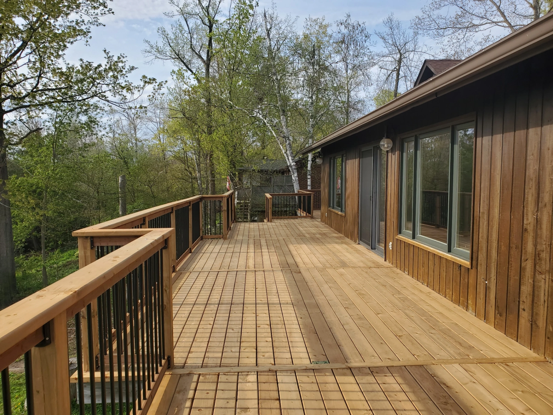Expansive wrap-around cedar deck overlooking the trees