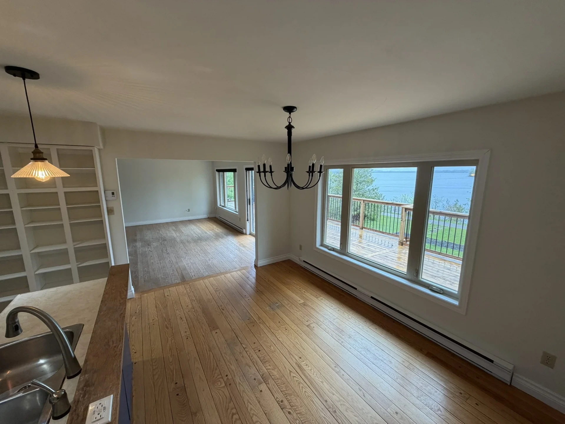 Dining area with chandelier and wide windows overlooking Cameron Lake