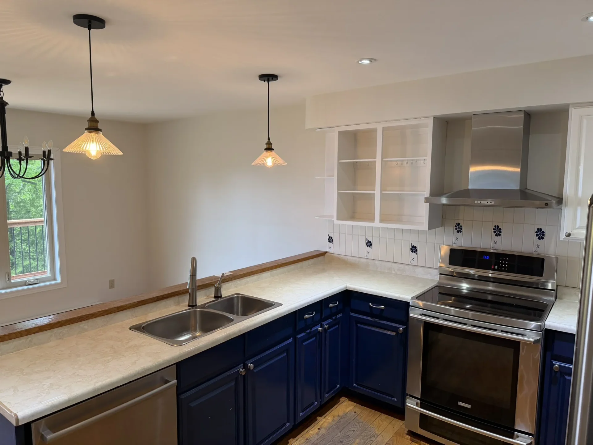 Kitchen with double sink, pendant lighting, and pass over counters